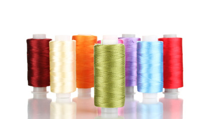 Many spools of thread isolated on white