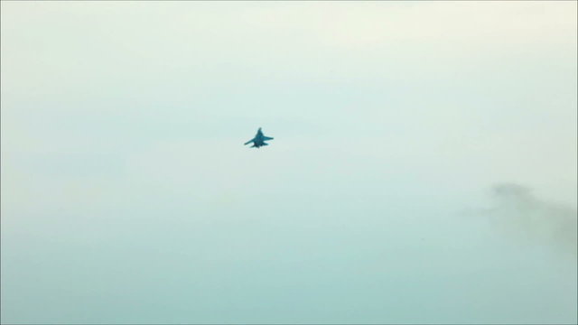 Fighter fly out in cloudy sky