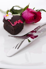 Obraz na płótnie Canvas Heart Shape Chocolate with rose