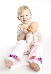 little girl playing with a doll