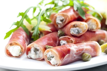 Fotobehang Voorgerecht Parma ham rolls filled with cream cheese, Galia melon and capers