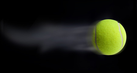 Tennis ball fast moving on black background