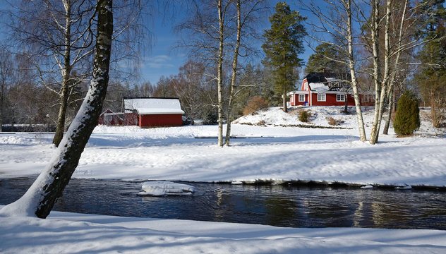 Winter landscape with Swedish cottage