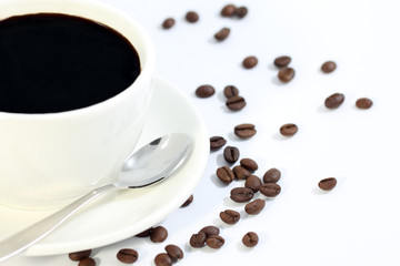 Cup of black coffee with grains close up