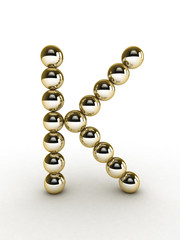 3d alphabet of gold beads.