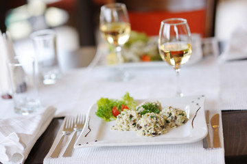 Delicious risotto with tomato and lettuce on a white plate
