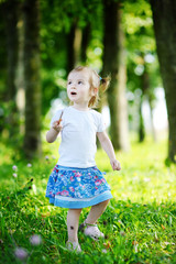 Adorable little girl portrait outdoors at summer