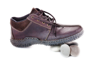 Brown men's shoes on the white stone presses