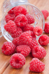 fresh raspberries spilling from a cup