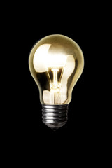 Classic Light bulb turned on isolated on black