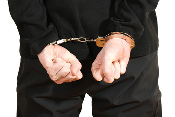 Bandit in black mask handcuffed isolated on white