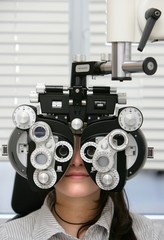 Junge Frau beim Sehtest beim Augenoptiker oder Augenarzt