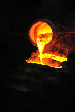 Foundry - metal poured from ladle into mould - emptying leftover