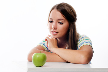 Portrait of a lovely young woman looking at fresh ripe apple iso