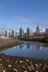 Vancouver skyscrapers reflect in lagoon at False Creek