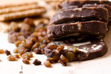 A composition with three slices of chocolate salami