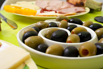 Green and black olive in bowl