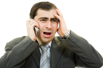 Businessman in distress speaks by phone on a white background