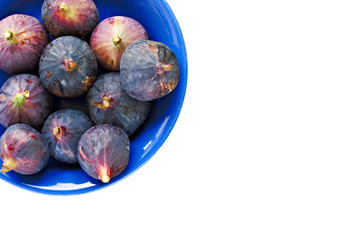 Bowl of ripe figs isolated on white