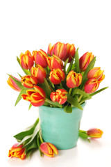 Beautiful bouquet of tulips in vase on white background.