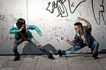 Young urban couple dancers hip hop dancing fight acting urban