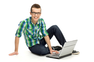 Young man sitting with laptop