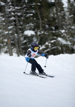 Little skier doing slalom