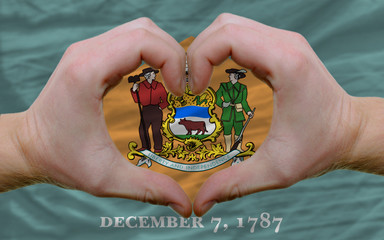 over american state flag of delaware showed heart and love gestu