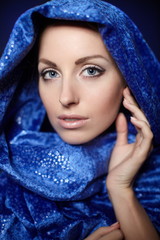 Beautiful woman bright makeup in blue color cloth