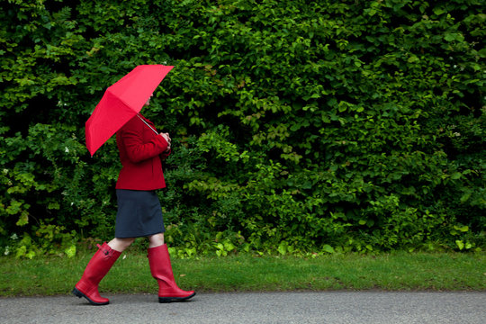 Woman In Red Walking With Umbrella