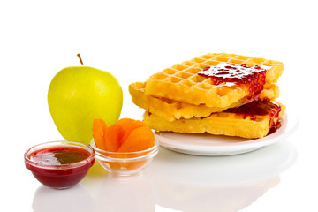 Tasty waffles with jam on plate isolated on white
