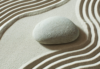 Fototapeta na wymiar zen pebble isolated on sand