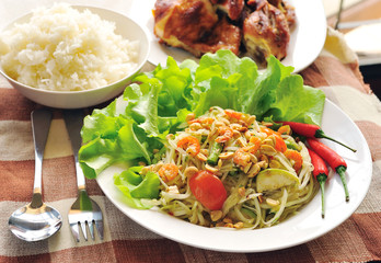 Somtum Thai food and spicy food on a white dish