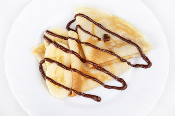 Thin pancakes with banana and chocolate
