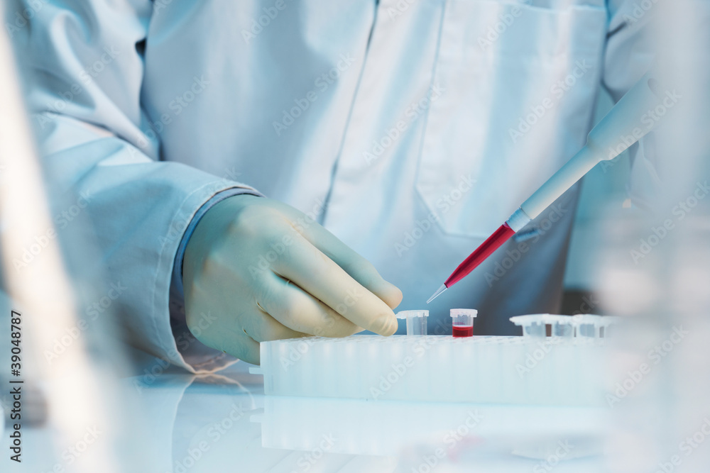 Sticker close up of scientist using pipette in laboratory