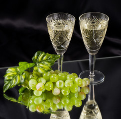 White wine in glass with grape