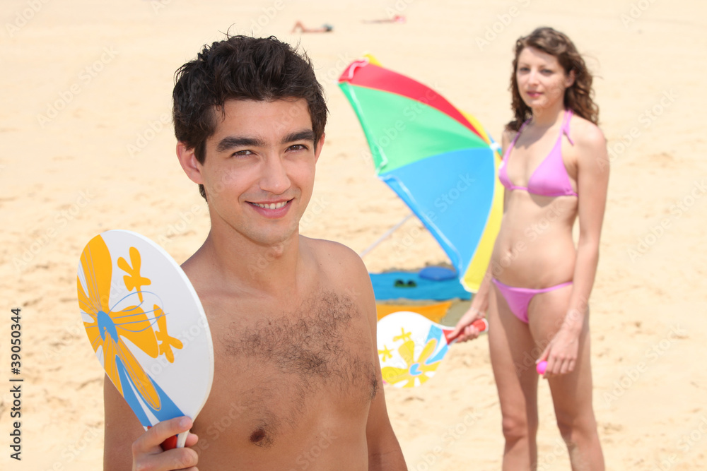 Wall mural portrait of a couple play on the beach