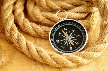 Fototapeta na wymiar black compass and marine rope