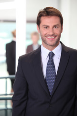 Fototapeta premium Smiling business man standing