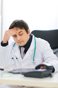 Concerned Medical Doctor Picking Up Phone