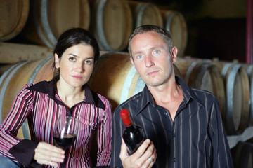 Man and woman with glass and bottle of wine