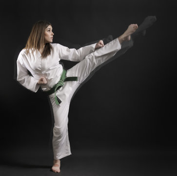 woman - master of karate performs a high kick- 01.