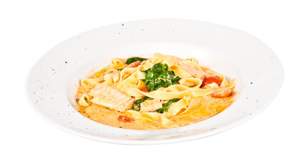 tasty pasta with cream, salmon, cheese and parsley close up