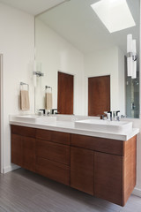Fototapeta na wymiar Contemporary Bathroom with Dual Sinks, Mirror and Towel Rack