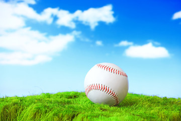 base ball in green grass field with sky