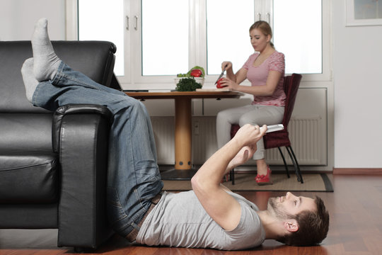 A young man plays with his Tablet PC at home