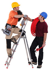 two electrician stood with step-ladder