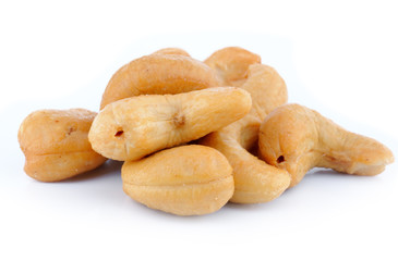 Pile of roasted cashew nuts in isolated white background
