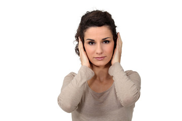 Woman covering her ears