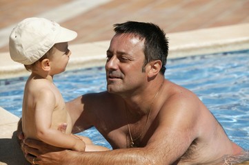 Father with his child in a swimming pool